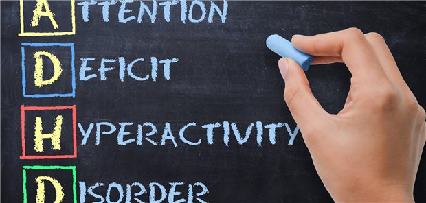 ADHD - Aufmerksamkeitsdefizit-Hyperaktivitätsstörung, handschriftlich von einer Frau auf eine Tafel geschrieben.