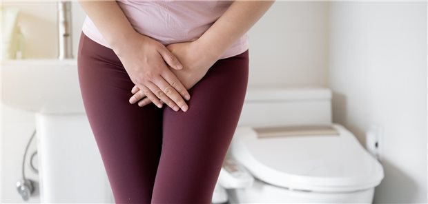 Eien Frau verkreuzt die Beine, als müsste sie dringend aufs WC.