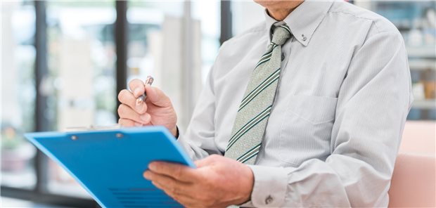 Ein älterer Herr, der einen medizinischen Fragebogen ausfüllt.