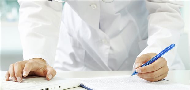 Approbation im Ausland aberkannt? Befugnisse der hiesigen Ärztekammern begrenzt Ein Arzt am Tablett hält einen Stift in der Hand-