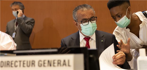 Tedros Adhanom Ghebreyesus, left, Director General of the World Health Organization (WHO), talks with a WHO's staff, prior the first day of the 75th World Health Assembly at the European headquarters of the United Nations in Geneva, Switzerland, Sunday, May 22, 2022.